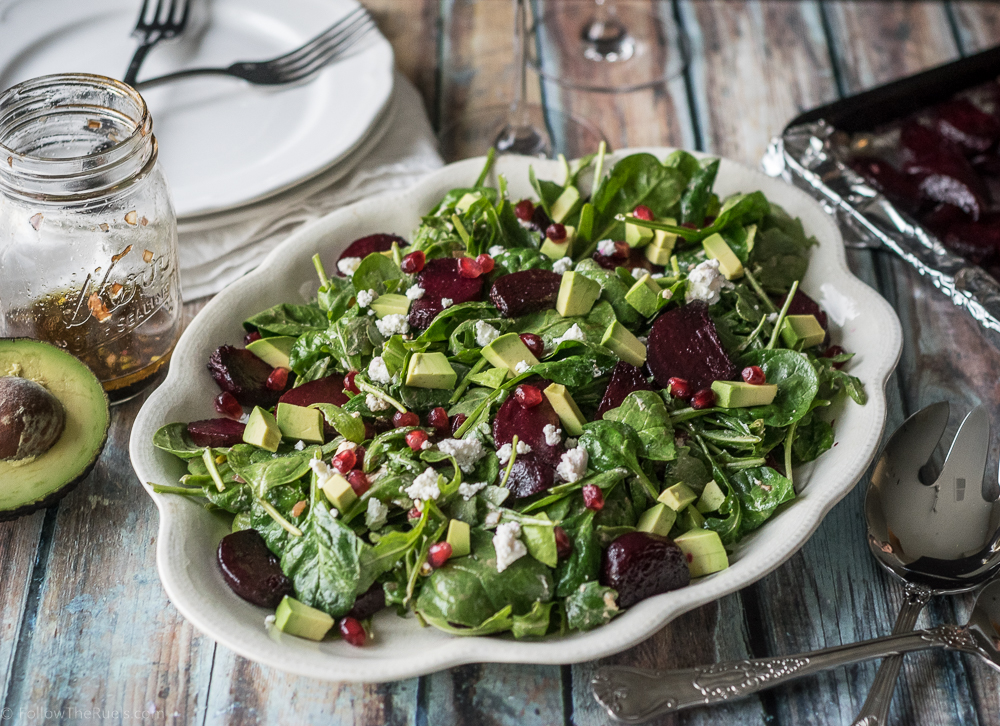 Roasted Beet and Arugula salad topped with avocado, goat cheese, and pomegranate